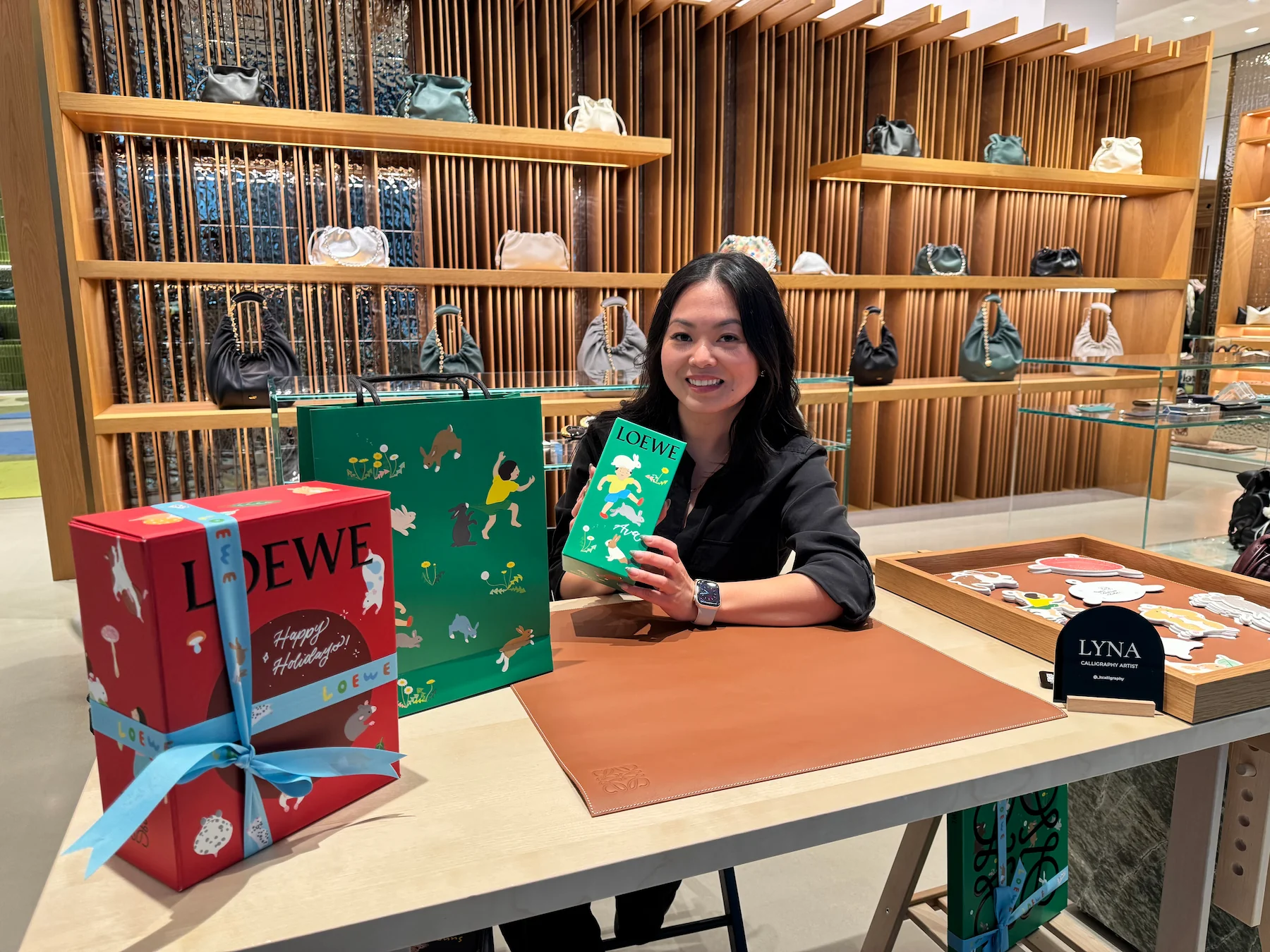 Lyna personalizing items at a luxury retail event table